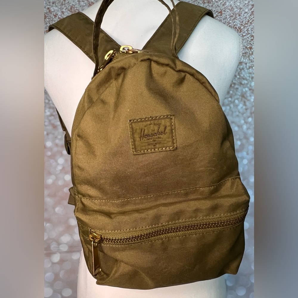 Dark green mini backpack.